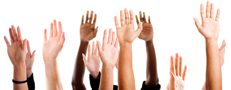 Multicolored hands raised to ask frequently asked questions